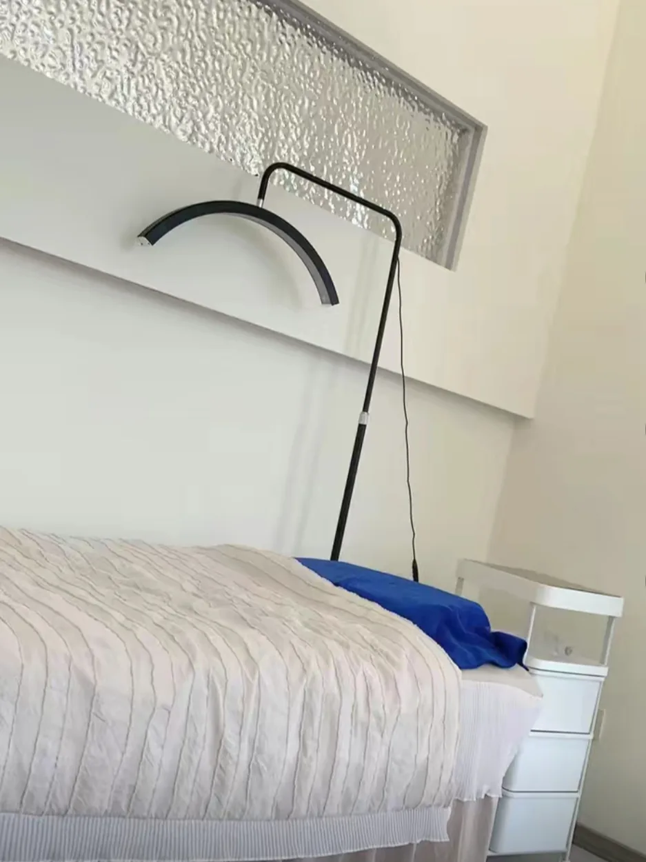 Floor-standing beauty lamp beside a treatment bed